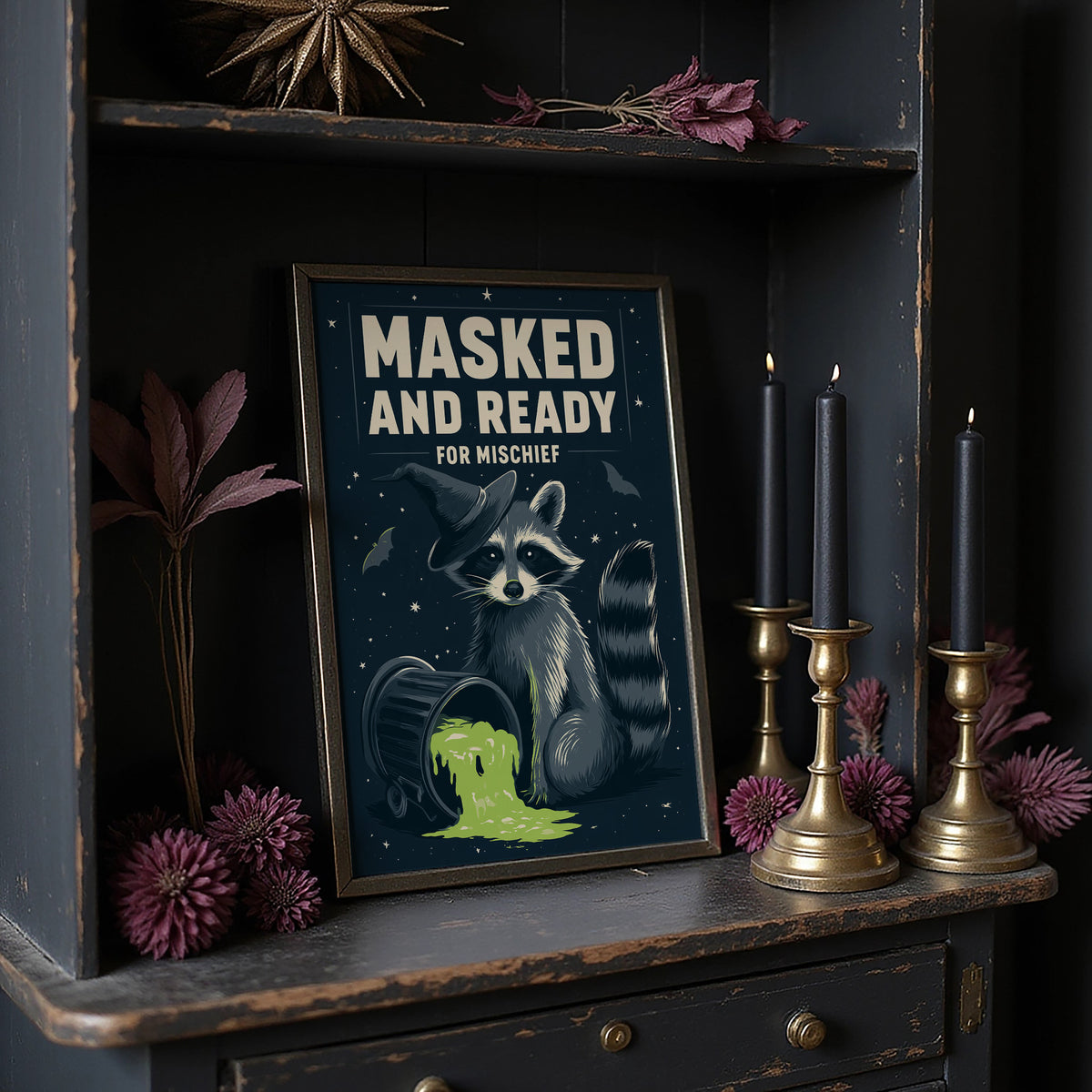 Mischief Wears a Mask, a masked raccoon beside a puddle of glowing green slime under bold cream lettering that reads masked and ready for mischief, on a dark wooden cabinet shelf with candles and dried flowers