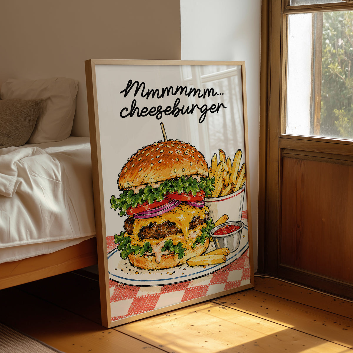 Mmmm Cheeseburger Makes Everything Better, a stacked cheeseburger with lettuce, tomato, cheese and a sesame bun beside fries and ketchup cups on a red and white checkered plate, with the lettering Mmmmm cheeseburger in black script across the top, leaning on a wood floor in a bedroom beside white linen bedding