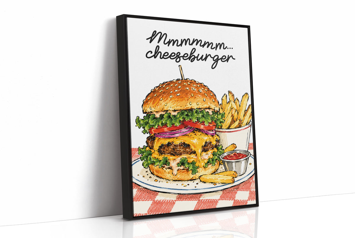Mmmm Cheeseburger Makes Everything Better, a stacked cheeseburger with lettuce, tomato, cheese and a sesame bun beside fries and ketchup cups on a red and white checkered plate, with the lettering Mmmmm cheeseburger in black script across the top, as a framed canvas in a black frame