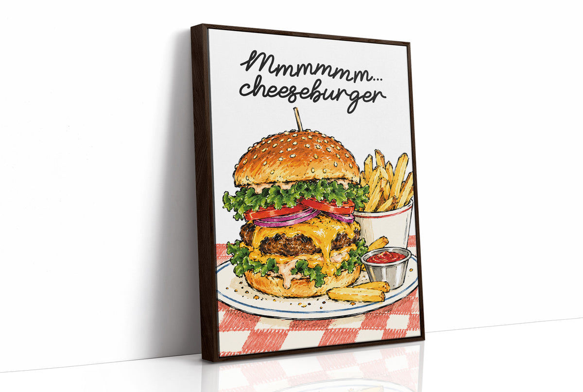 Mmmm Cheeseburger Makes Everything Better, a stacked cheeseburger with lettuce, tomato, cheese and a sesame bun beside fries and ketchup cups on a red and white checkered plate, with the lettering Mmmmm cheeseburger in black script across the top, as a framed canvas in a brown frame