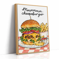 Mmmm Cheeseburger Makes Everything Better, a stacked cheeseburger with lettuce, tomato, cheese and a sesame bun beside fries and ketchup cups on a red and white checkered plate, with the lettering Mmmmm cheeseburger in black script across the top, as a framed canvas in a natural wood frame