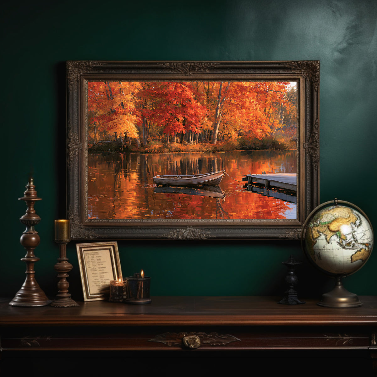 One Quiet Row Before Winter, autumn lake with red maples and a rowboat painting, in an ornate dark frame on a deep green wall above a mantel with a globe and candles