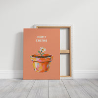 One Small Bloom in Clay, a single white flower rising from a painted clay pot in coral, gold and pink brushstrokes, on a peach ground with two lines of bold pale lettering above, in a loose painterly style, on a gallery canvas with wrapped edges leaning against a white wall