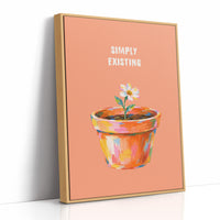 One Small Bloom in Clay, a single white flower rising from a painted clay pot in coral, gold and pink brushstrokes, on a peach ground with two lines of bold pale lettering above, in a loose painterly style, as a framed canvas in a natural wood frame