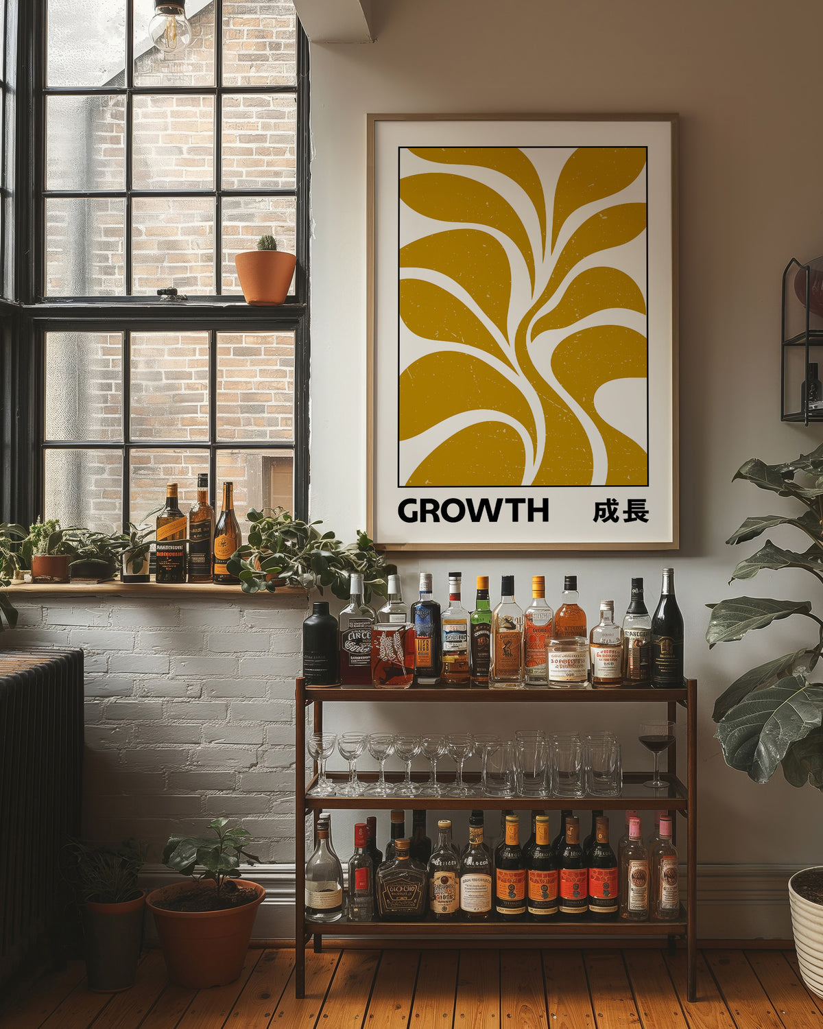 Patient Leaves Turning Toward Light, a stylized mustard leaf motif in curved shapes on a cream ground, with the word GROWTH in black capitals and a small Japanese word beside it, in a wood frame on a brick wall above a bar cart of bottles and plants