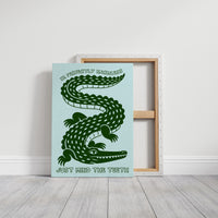 Perfectly Harmless, Mind the Teeth, a deep green crocodile curling down a pale mint ground, with a bold hand lettered line above reading I'M PERFECTLY HARMLESS and one below reading JUST MIND THE TEETH, on a gallery canvas with wrapped edges leaning against a white wall