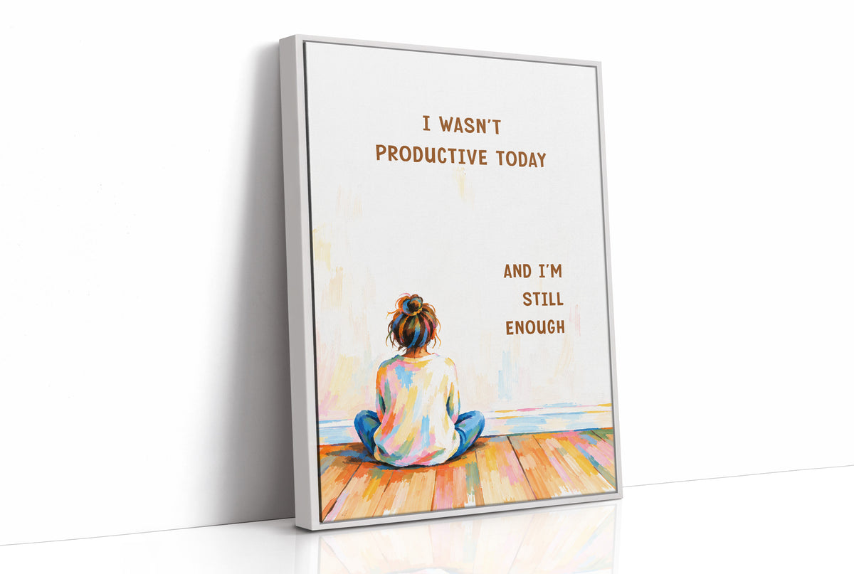 Quiet Hours on Painted Floors, a child seen from behind sitting cross legged on painted floorboards in coral, blue and cream, with two lines of bold brown lettering on a pale cream ground, in a soft illustrated style, as a framed canvas in a white frame