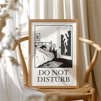 Quiet Hours Until Someone Knocks, a black ink woodcut style scene of a woman asleep in bed beside a lamp and a small framed plant picture while horned shadows lurk at the open door, and the words DO NOT DISTURB in black serif capitals on cream paper, in a dark wood frame on a floral wallpaper wall above a rustic cabinet and a vase