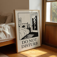 Quiet Hours Until Someone Knocks, a black ink woodcut style scene of a woman asleep in bed beside a lamp and a small framed plant picture while horned shadows lurk at the open door, and the words DO NOT DISTURB in black serif capitals on cream paper, in a wood frame on a leather armchair beside a stack of books