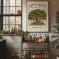 Roots That Remember the Ground, a banyan tree with a wide green canopy and many aerial roots hanging to the ground, drawn in a framed Japanese travel poster style with katakana above and BANYAN TREE below, in a wood frame on a brick wall above a bar cart of bottles and plants
