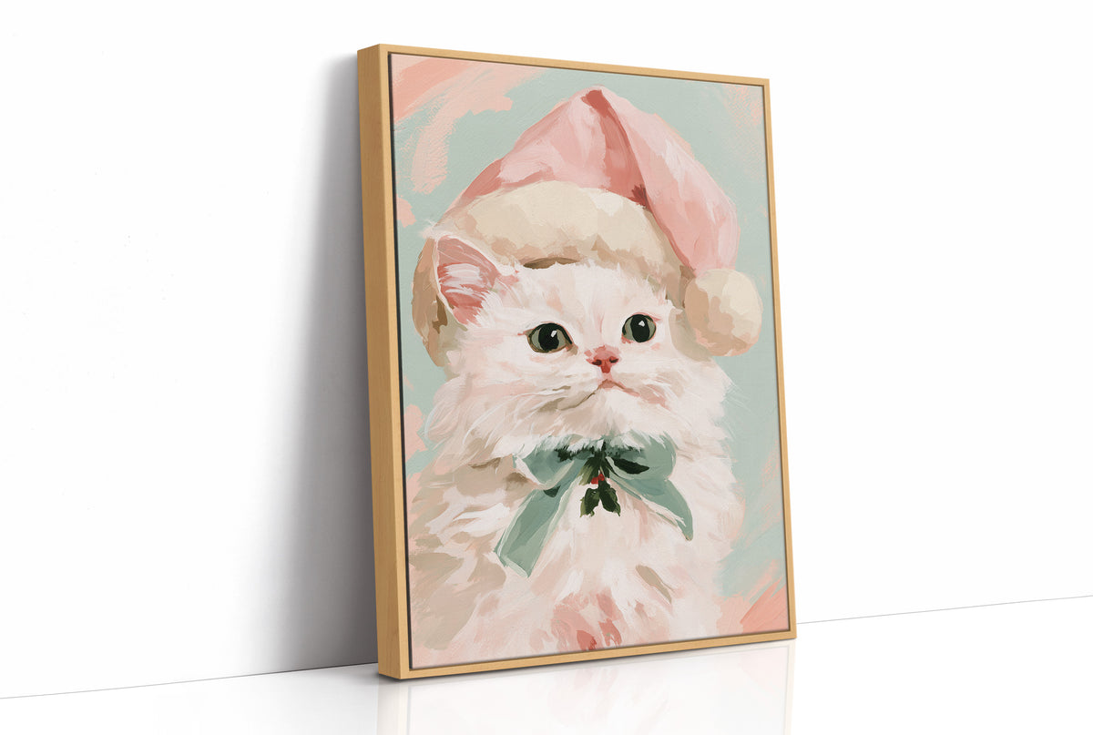 She Dressed Up for the Season, a white kitten in a pink Santa style hat and a mint bow, painted in blush, mint and cream on a soft pastel ground, as a framed canvas in a natural wood frame