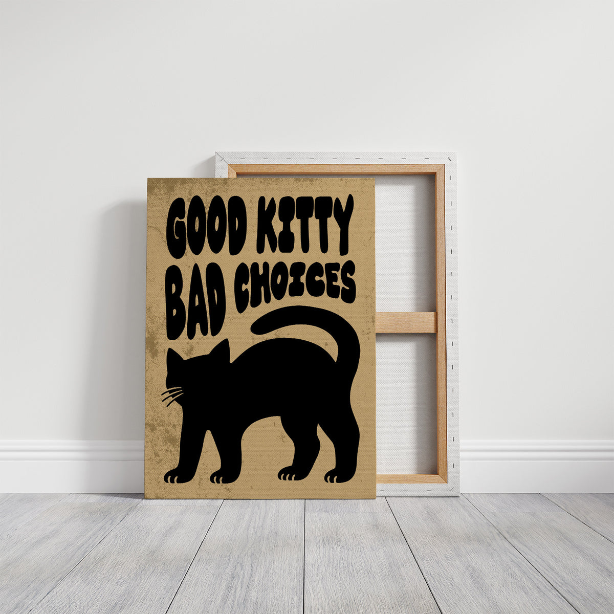 Sleek Silhouette, Questionable Taste, a solid black cat silhouette with a long tail curled up the side, standing on tan paper with the words GOOD KITTY BAD CHOICES in bold black lettering, on a gallery canvas with wrapped edges leaning against a white wall