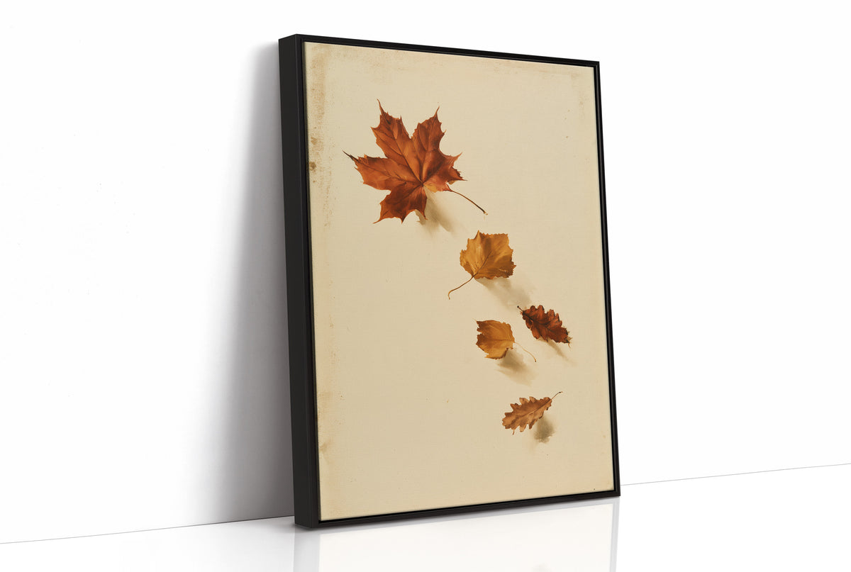 Slow Descent of the Maples, a trail of maple leaves in rust, amber and gold drifting diagonally across a warm beige ground, as a framed canvas in a black frame