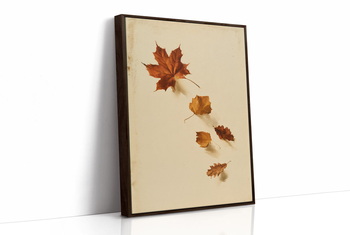 Slow Descent of the Maples, a trail of maple leaves in rust, amber and gold drifting diagonally across a warm beige ground, as a framed canvas in a brown frame
