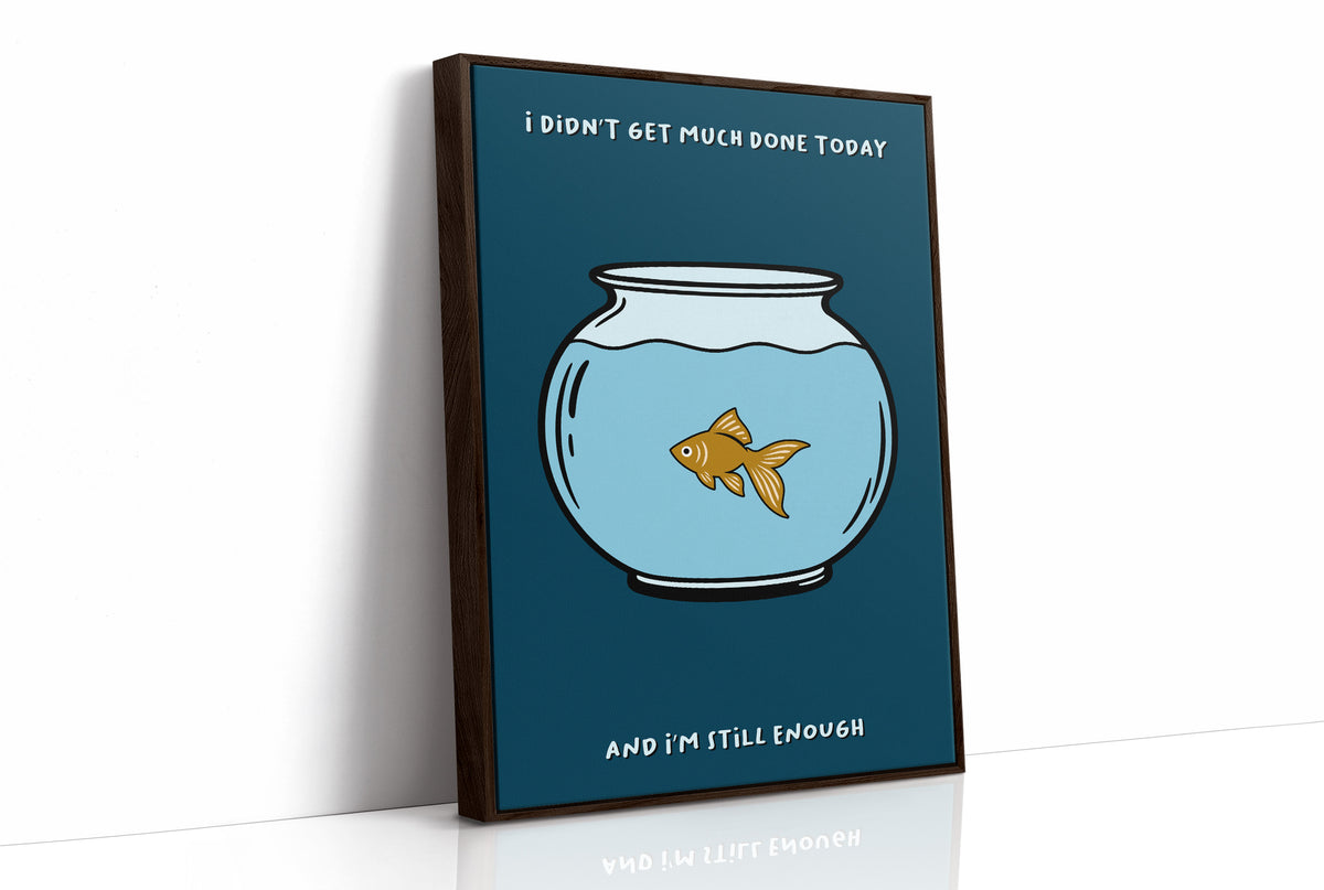 Still Enough for Today, a round glass fishbowl with one goldfish on a deep navy ground, a line of cream lettering above and below in a cartoon style, painted in navy, pale blue and orange, as a framed canvas in a brown frame
