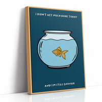 Still Enough for Today, a round glass fishbowl with one goldfish on a deep navy ground, a line of cream lettering above and below in a cartoon style, painted in navy, pale blue and orange, as a framed canvas in a natural wood frame