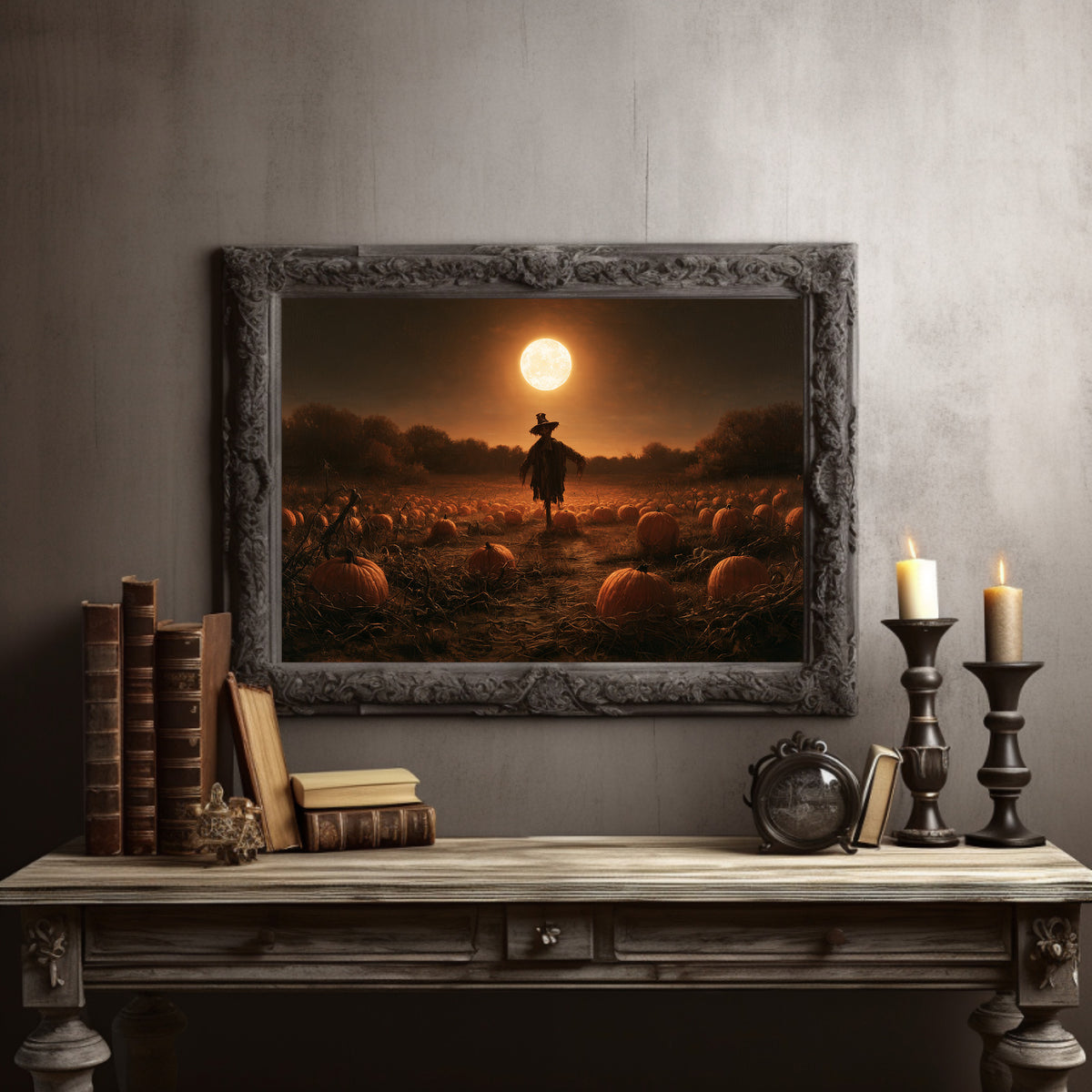 Still on Duty at Midnight, a scarecrow standing in a pumpkin field under a huge moon, painted in dark amber and burnt orange, in a dark carved frame on a gray wall above a console table with candlesticks and old books