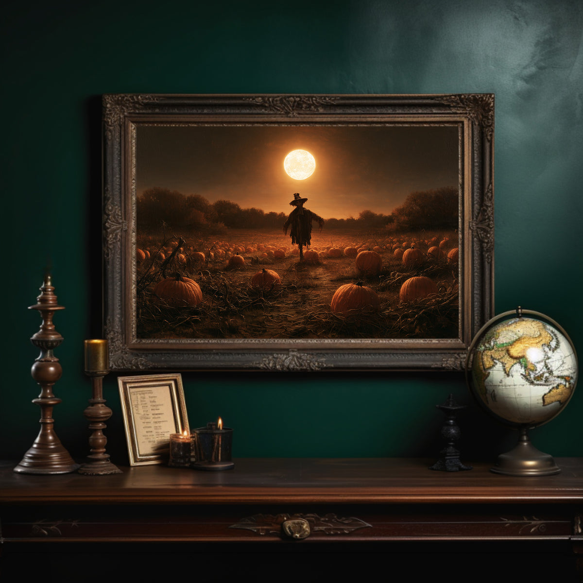 Still on Duty at Midnight, a scarecrow standing in a pumpkin field under a huge moon, painted in dark amber and burnt orange, in an ornate dark frame on a deep green wall above a mantel with a globe and candles