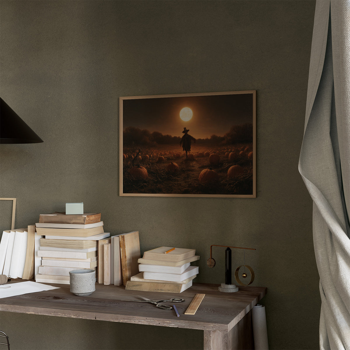 Still on Duty at Midnight, a scarecrow standing in a pumpkin field under a huge moon, painted in dark amber and burnt orange, in a thin wood frame on a moss green wall above a desk stacked with books