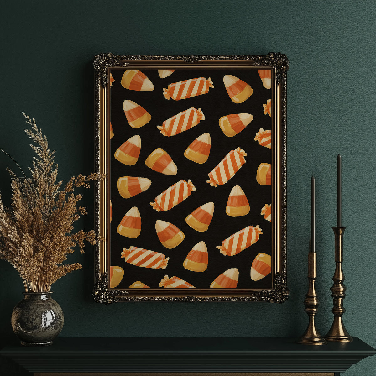Stripes Kept for Later, a repeating pattern of candy corn kernels in cream, orange and butter yellow on a deep black ground, in an ornate gold frame on a deep green wall beside tall brass candlesticks