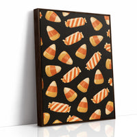 Stripes Kept for Later, a repeating pattern of candy corn kernels in cream, orange and butter yellow on a deep black ground, as a framed canvas in a brown frame