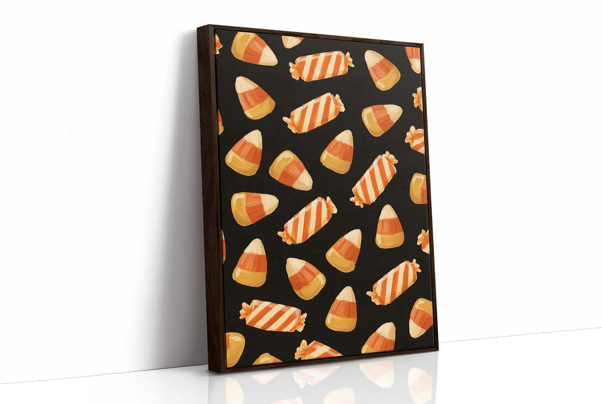 Stripes Kept for Later, a repeating pattern of candy corn kernels in cream, orange and butter yellow on a deep black ground, as a framed canvas in a brown frame