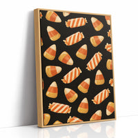 Stripes Kept for Later, a repeating pattern of candy corn kernels in cream, orange and butter yellow on a deep black ground, as a framed canvas in a natural wood frame