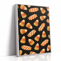 Stripes Kept for Later, a repeating pattern of candy corn kernels in cream, orange and butter yellow on a deep black ground, as a framed canvas in a white frame
