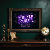 Taste the Magic Tonight, violet neon sign reading the hexed parlor on a black painting, in an ornate dark frame on a deep green wall above a mantel with a globe and candles