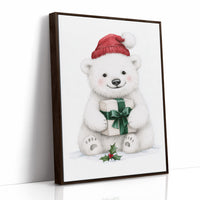The Bear Cub Keeps a Secret, a small polar bear cub in a red knit hat hugging a green wrapped gift with a sprig of holly at its feet, on a soft cream ground, as a framed canvas in a brown frame