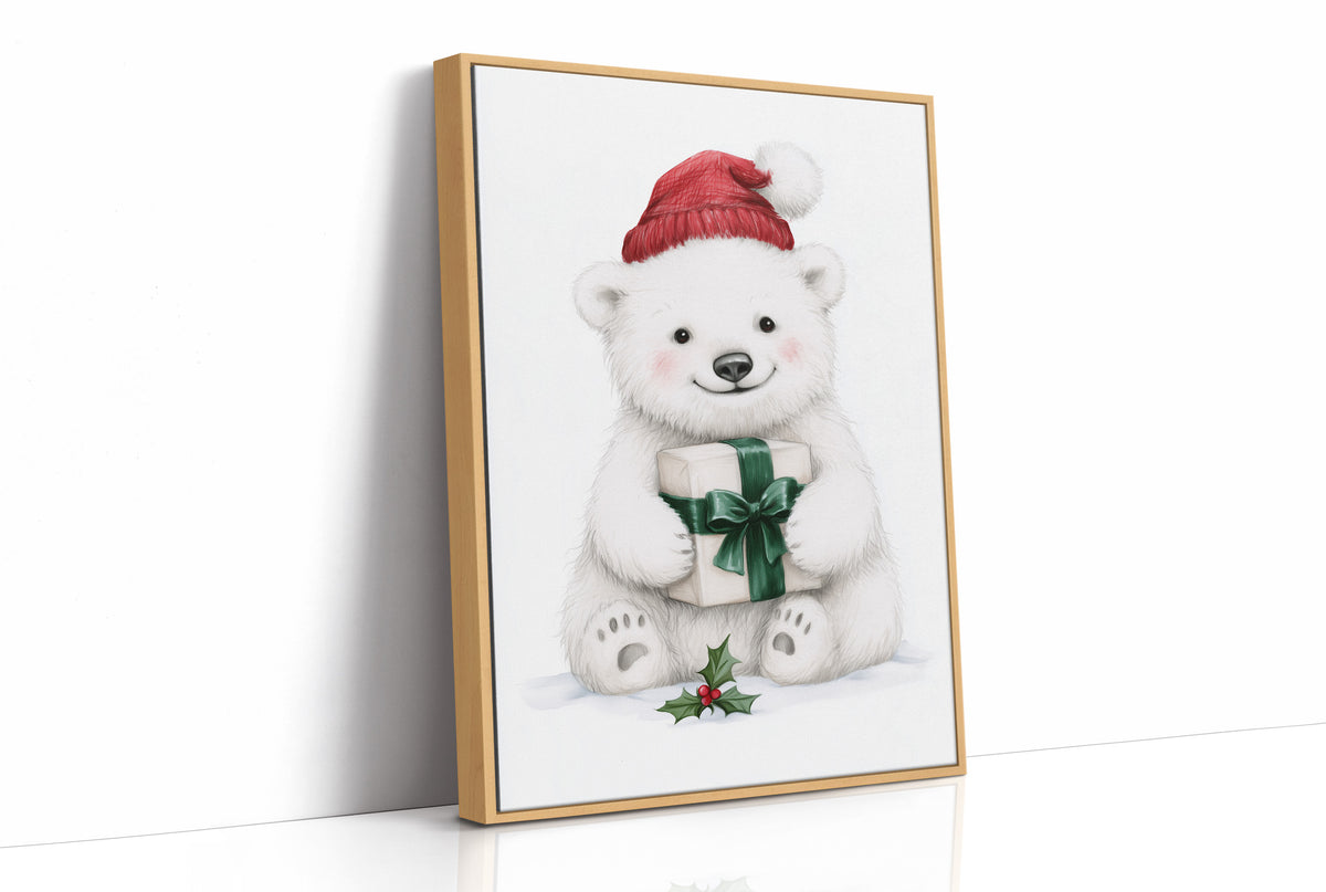 The Bear Cub Keeps a Secret, a small polar bear cub in a red knit hat hugging a green wrapped gift with a sprig of holly at its feet, on a soft cream ground, as a framed canvas in a natural wood frame