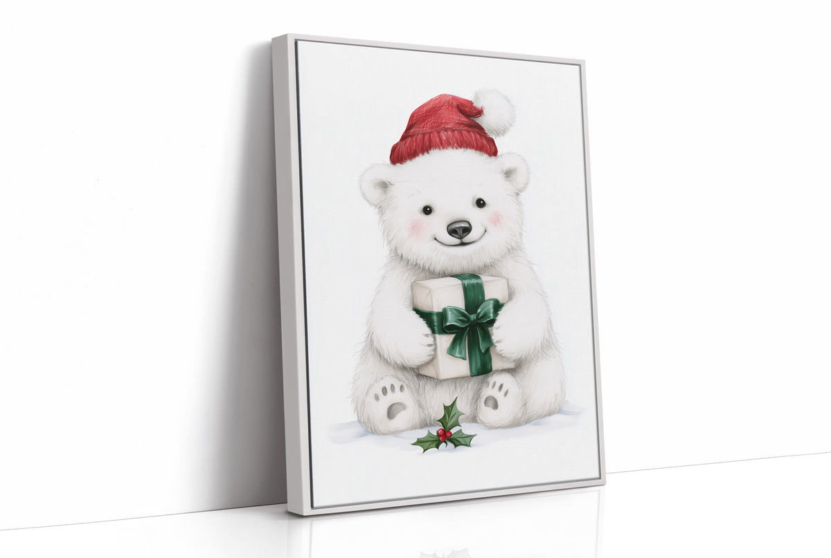The Bear Cub Keeps a Secret, a small polar bear cub in a red knit hat hugging a green wrapped gift with a sprig of holly at its feet, on a soft cream ground, as a framed canvas in a white frame