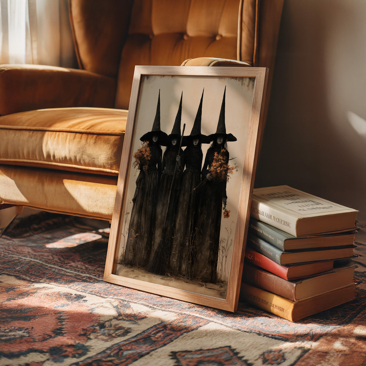 The Coven Keeps Its Silence, five witches in tall pointed hats standing shoulder to shoulder, painted in black, charcoal and dusty cream, in a wood frame on a rug beside a leather armchair and stacked books
