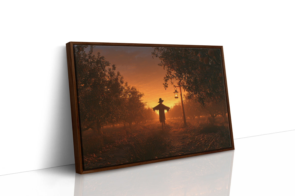 The Field Keeps Its Last Light, a scarecrow standing in a rural sunset field of amber sky and rust colored grass, painted in burnt orange, dusky gold and deep brown, as a framed canvas in a brown frame