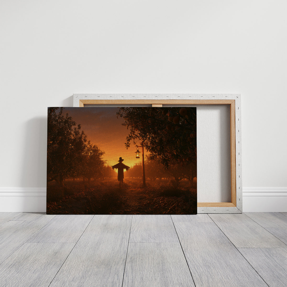 The Field Keeps Its Last Light, a scarecrow standing in a rural sunset field of amber sky and rust colored grass, painted in burnt orange, dusky gold and deep brown, on a gallery canvas with wrapped edges leaning against a white wall