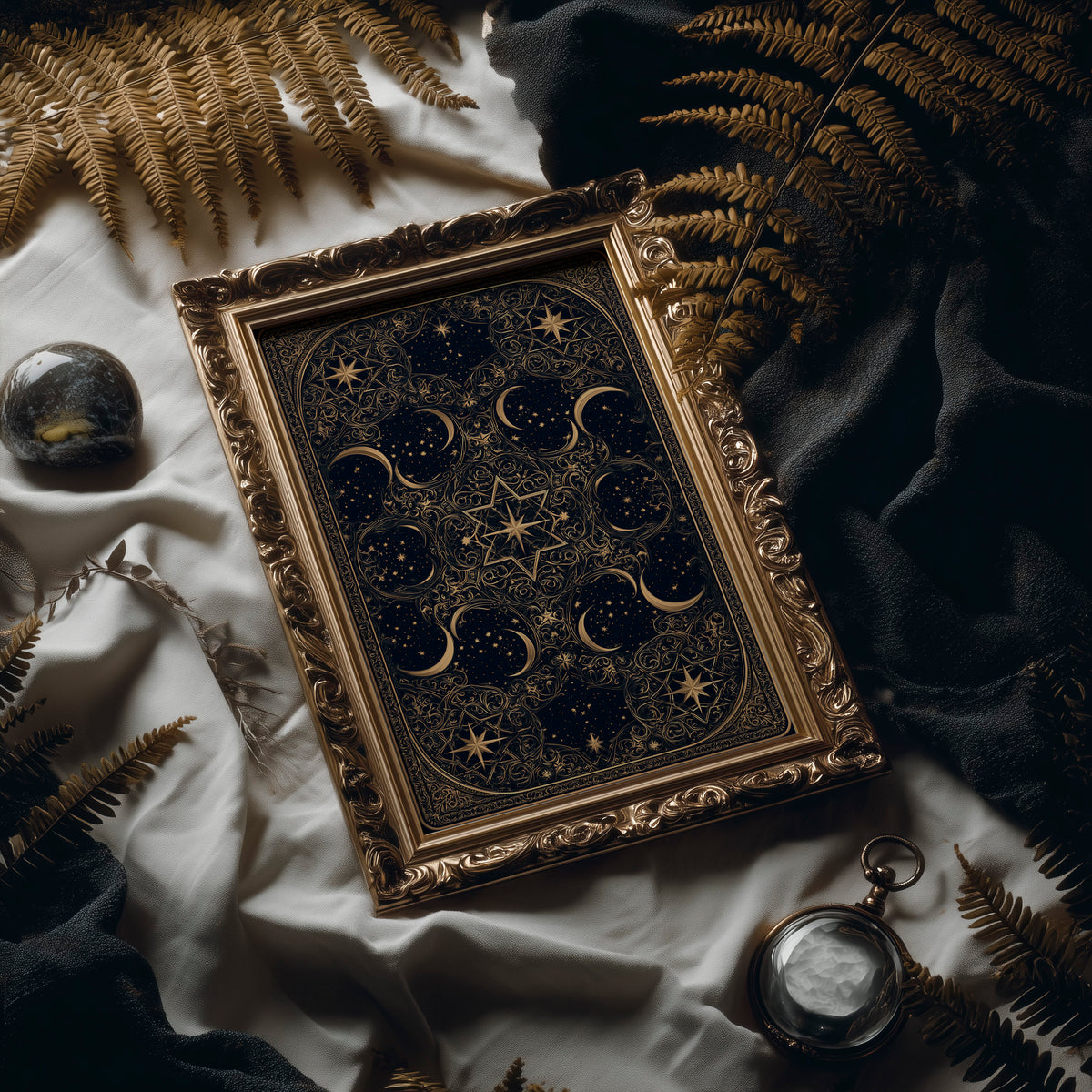 The Gilded Wheel of Midnight, a gold ornamental mandala of moon phases and stars on a deep navy field, painted in navy and antique gold, in an antique gold frame laid on white linen with ferns and a pocket watch