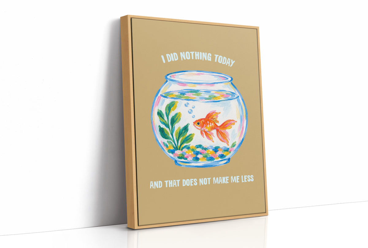 The Goldfish Takes the Afternoon, a goldfish circling a round bowl of pale blue water with green plants, with three lines of cream lettering on a mustard ground, in a flat playful illustrated style painted in mustard, blue and cream, as a framed canvas in a natural wood frame