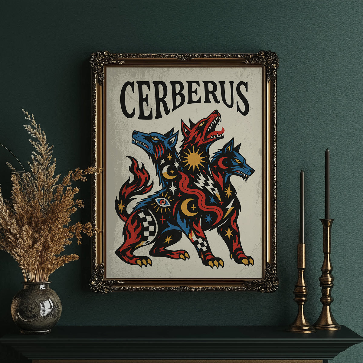 The Hound at the Threshold, a hound with several heads in red, blue and gold, with dark outlines and star and moon marks, in a bold flash sheet style with a black lettered name across the top, in an ornate gold frame on a deep green wall beside tall brass candlesticks