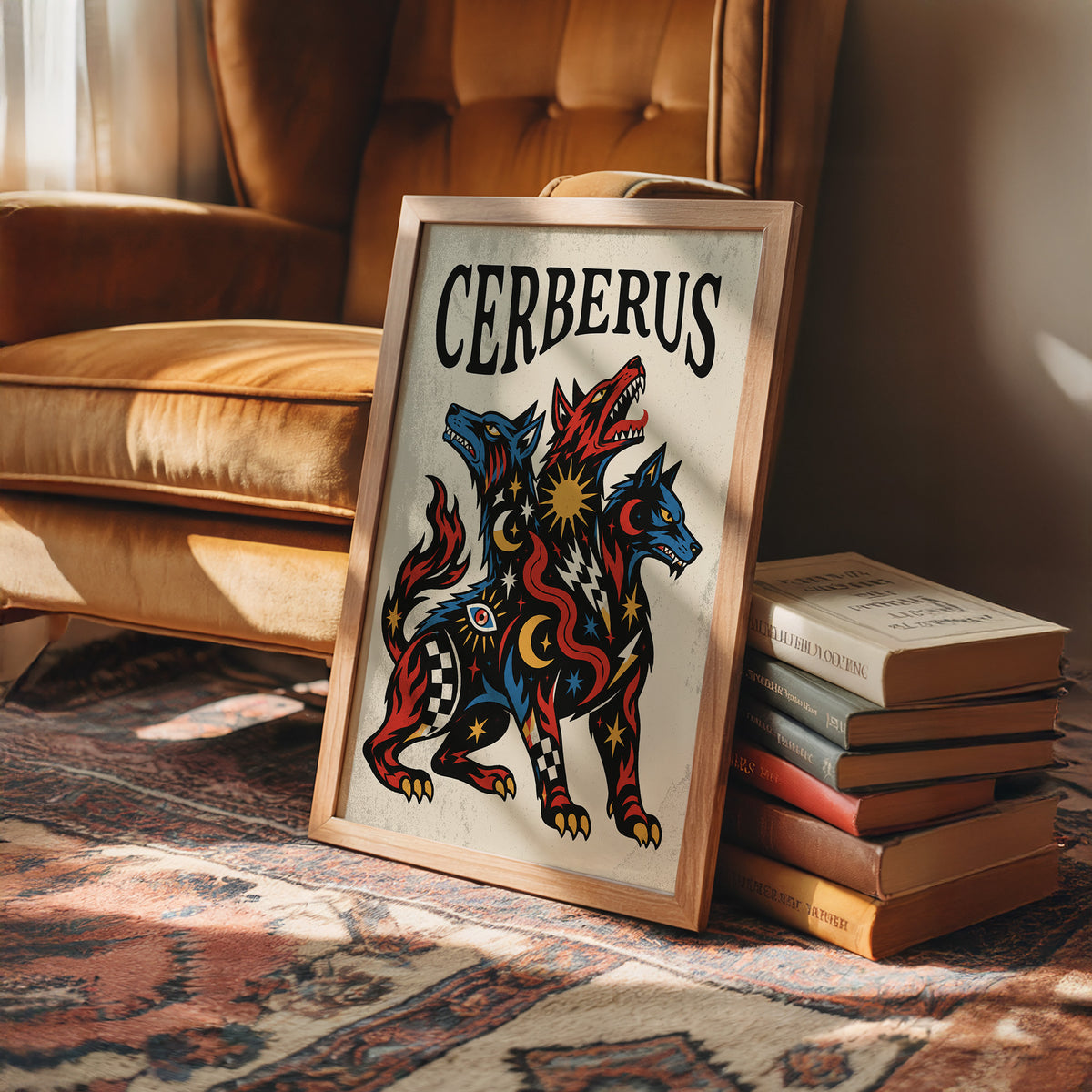 The Hound at the Threshold, a hound with several heads in red, blue and gold, with dark outlines and star and moon marks, in a bold flash sheet style with a black lettered name across the top, in a wood frame on a leather armchair beside a stack of books