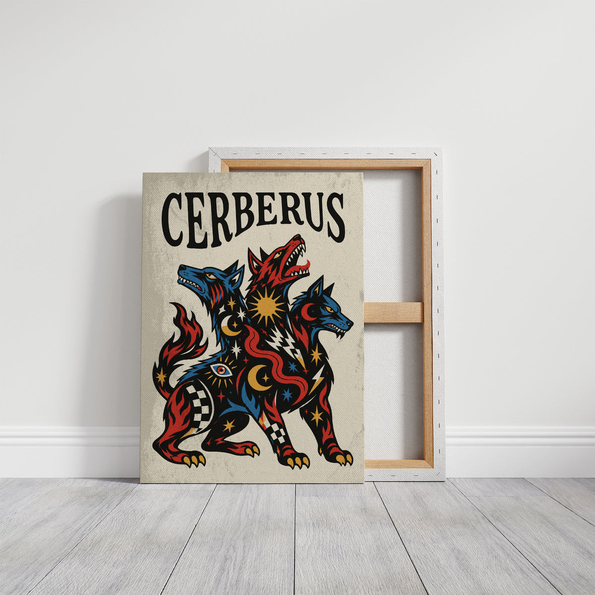 The Hound at the Threshold, a hound with several heads in red, blue and gold, with dark outlines and star and moon marks, in a bold flash sheet style with a black lettered name across the top, on a gallery canvas with wrapped edges leaning against a white wall