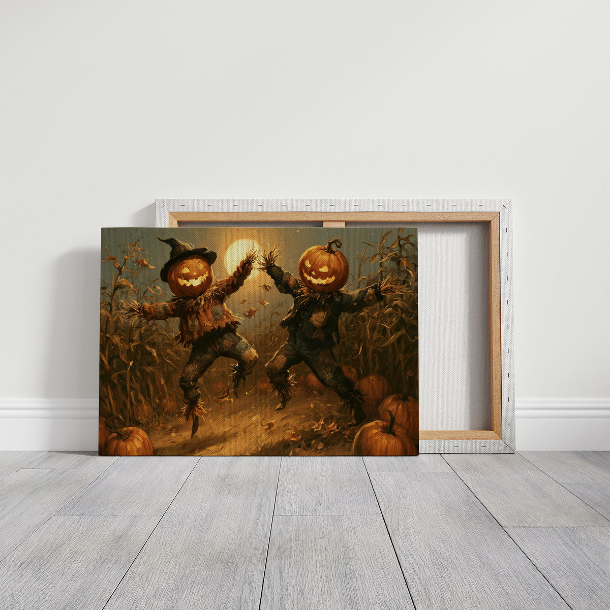 The Hour the Scarecrows Dance, two pumpkin headed figures with glowing faces dancing in a golden field under a moon, painted in amber, burnt orange and deep brown, on a gallery canvas with wrapped edges leaning against a white wall