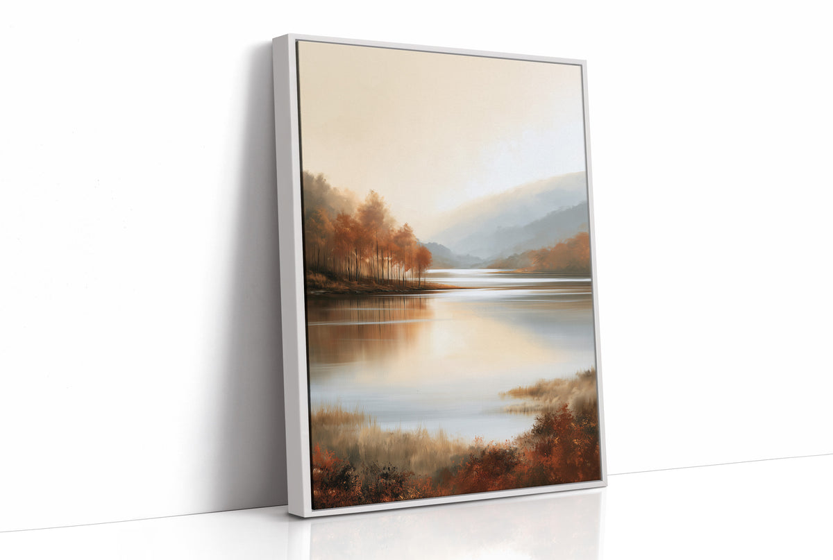 The Lake Remembers Autumn, an autumn lake at dusk with a line of turning trees on the near shore and pale mountains beyond, the water mirroring the sky in soft blue and amber, as a framed canvas in a white frame