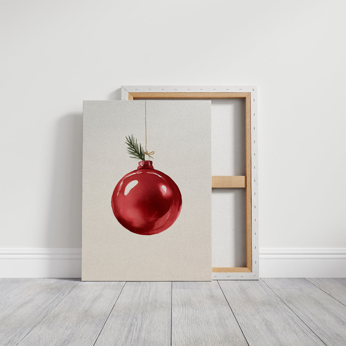 The Last Bauble on the Branch, a single red glass ornament hanging from a thin cord with a sprig of pine tip, on a cream ground, on a gallery canvas with wrapped edges leaning against a white wall