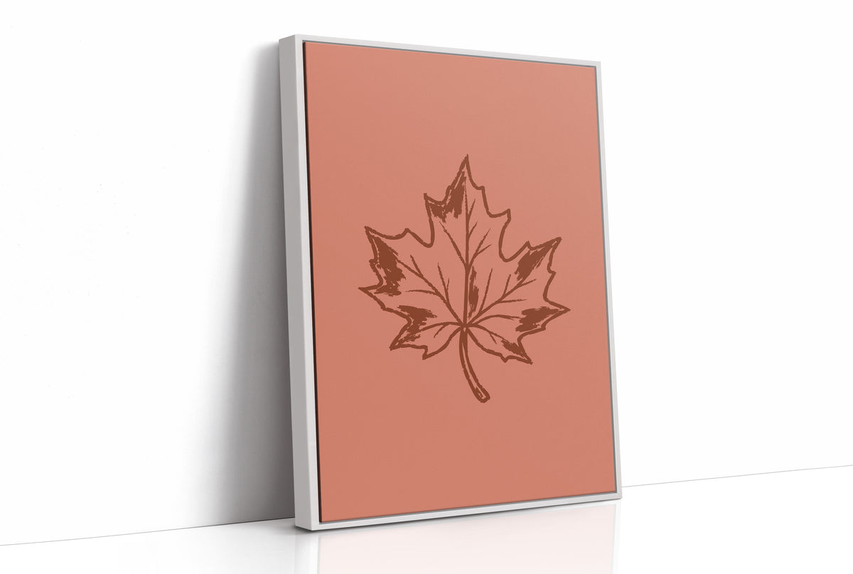 The Maple Keeps Its Last Light, a single maple leaf drawn in fine brown outline on a dusty terracotta ground, a botanical line study with soft shading, as a framed canvas in a white frame