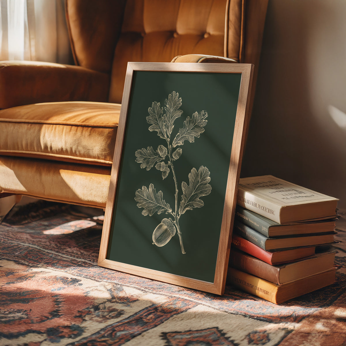The Oak Keeps Its Harvest Close, a sprig of lobed oak leaves and three acorns drawn in pale cream lines on a deep forest green ground, in a botanical study style, in a wood frame on a rug beside a leather armchair and a stack of books