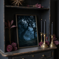 The Old Oak Keeps Its Midnight, gnarled trees rising out of a blue mist on a moonlit night, painted in deep navy, pale fog and charcoal shadow, on a dark wooden cabinet shelf with candles and dried flowers