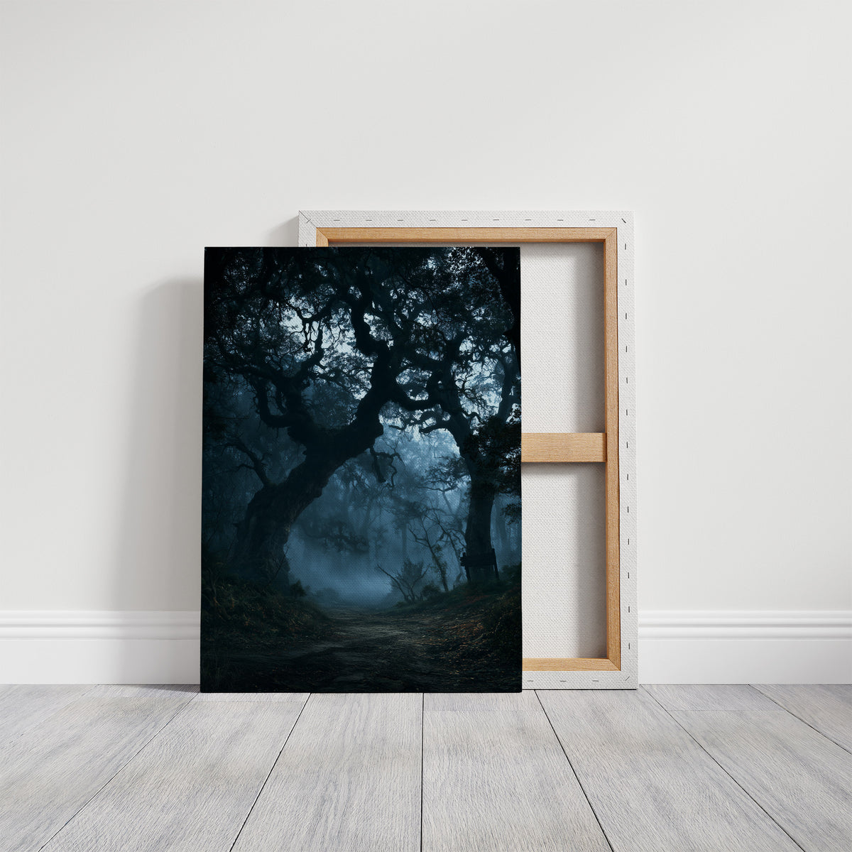 The Old Oak Keeps Its Midnight, gnarled trees rising out of a blue mist on a moonlit night, painted in deep navy, pale fog and charcoal shadow, on a gallery canvas with wrapped edges leaning against a white wall