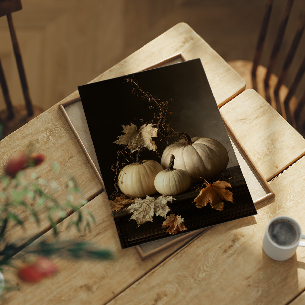 The Pale Ones Keep Their Vigil, three pale pumpkins and a few gold oak leaves in a still life on a deep black ground, with dried vine stems curling above, painted in cream, ochre and charcoal, lying flat on a light wood table beside a coffee cup and red berries