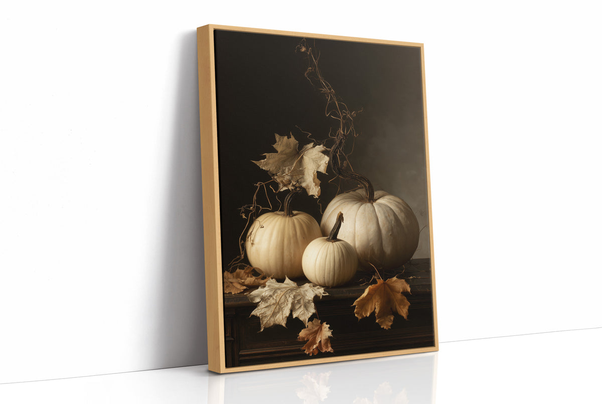 The Pale Ones Keep Their Vigil, three pale pumpkins and a few gold oak leaves in a still life on a deep black ground, with dried vine stems curling above, painted in cream, ochre and charcoal, as a framed canvas in a natural wood frame