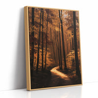 The Path Bends Toward Home, an autumn forest path winding between tall dark trunks, lit by a shaft of golden light across the leaves, painted in rust, amber and deep brown, as a framed canvas in a natural wood frame